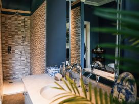 A bathroom with a shower and sink at St Anne's Manor in Torquay