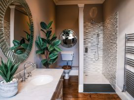 A bathroom with a sink, toilet, and shower at St Anne's Manor, Torquay