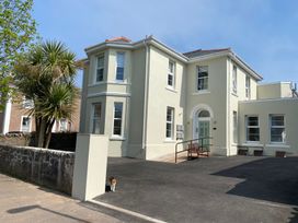 A building with windows and driveway at The Falstone Apartment in Torquay