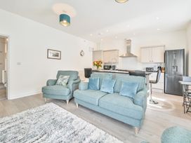 A living room with a kitchen and sofa at The Falstone Apartment in Torquay