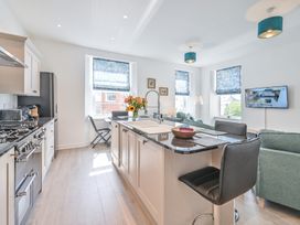 A kitchen with a stove and refrigerator at The Falstone Apartment in Torquay