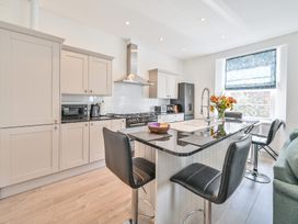 A kitchen with cabinets and appliances at The Falstone Apartment in Torquay