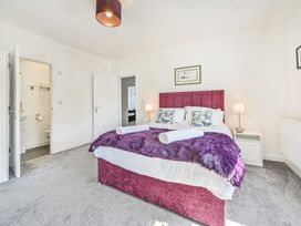 A bedroom with a bed and attached bathroom at The Falstone Apartment in Torquay