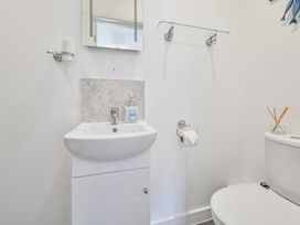 A bathroom with a sink and toilet at The Falstone Apartment in Torquay