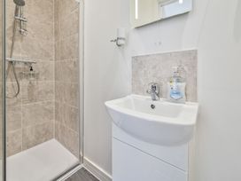 A bathroom with a shower and sink at The Falstone Apartment in Torquay