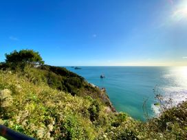 A coastal view with cliffs and islands at Upper Stable - The Stables Apartments at Meadfoot Bay Torquay