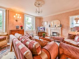 A living room with a sofa and a television at Muntham Luxury Town House with Hot Tub, Torquay