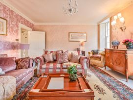 A living room with a sofa and armchair at Muntham Luxury Town House with Hot Tub in Torquay