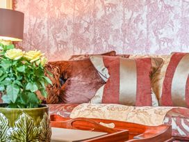 A living room with cushions and a flower pot at Muntham Luxury Town House with Hot Tub in Torquay