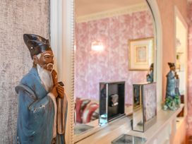 A living room with a statue and mirror at Muntham Luxury Town House with Hot Tub Torquay