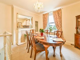 A dining room with a table and chairs at Muntham Luxury Town House with Hot Tub in Torquay