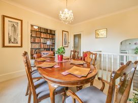 A dining room with a table and chairs at Muntham Luxury Town House with Hot Tub, Torquay