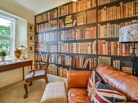 A study room with a bookshelf and desk at Muntham Luxury Town House with Hot Tub in Torquay