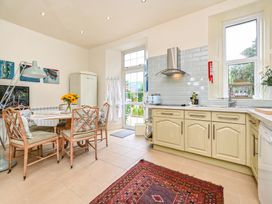 A kitchen with a table and chairs at Muntham Luxury Town House with Hot Tub in Torquay