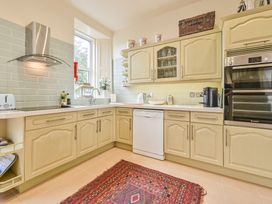 A kitchen with cabinets and appliances at Muntham Luxury Town House with Hot Tub in Torquay