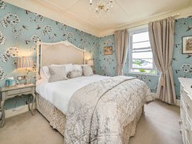 A bedroom with a bed and nightstands at Muntham Luxury Town House with Hot Tub in Torquay