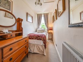 A bedroom with a bed and dresser at Muntham Luxury Town House with Hot Tub Torquay