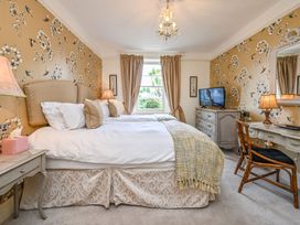 A bedroom with two beds and a television at Muntham Luxury Town House with Hot Tub in Torquay