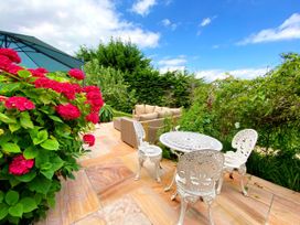 A garden with outdoor seating and flowers at Muntham Luxury Town House with Hot Tub in Torquay