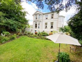 A garden with a house, steps, and plants at Muntham Luxury Town House with Hot Tub, Torquay