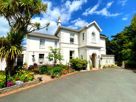A house with a garden and pathway at Muntham Deluxe Apartment 2 in Torquay