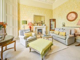 A living room with sofas and a fireplace at Muntham Deluxe Apartment 2 in Torquay