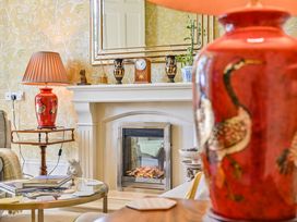 A living room with a fireplace and vase at Muntham Deluxe Apartment 2 in Torquay