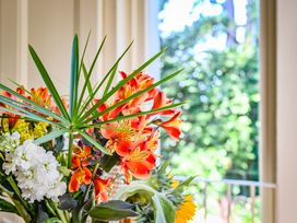 A bouquet of flowers by a window at Muntham Deluxe Apartment 2 Torquay
