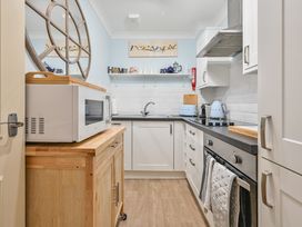 A kitchen with a microwave and kettle at Muntham Deluxe Apartment 2 Torquay