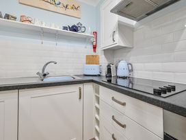 A kitchen with a sink, kettle, and toaster at Muntham Deluxe Apartment 2 in Torquay