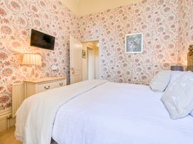A bedroom with a bed and lamp at Muntham Deluxe Apartment 2 in Torquay