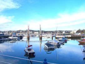 A marina with boats reflecting on water at Muntham Deluxe Apartment 2 in Torquay