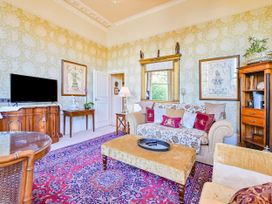 A living room with a sofa and television at Muntham Deluxe Apartment 3 in Torquay