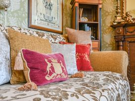 A living room with a sofa and decorative pillows at Muntham Deluxe Apartment 3 in Torquay