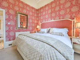 A bedroom with a bed and bedside tables at Muntham Deluxe Apartment 3 in Torquay