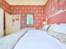 A bedroom with a bed and a window at Muntham Deluxe Apartment 3 in Torquay