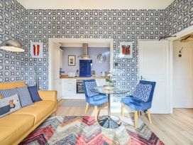 A living room with a sofa and kitchen area at Muntham Apartment 4 in Torquay