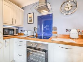 A kitchen with appliances and cabinetry at Muntham Apartment 4 in Torquay