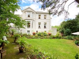 A house with garden and plants at Muntham Apartment 4 in Torquay