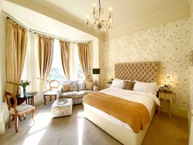 A bedroom with a bed and sofa at Muntham Studio Apartment 5 in Torquay