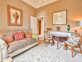 A living room with a sofa and side table at Muntham Apartment 6 in Torquay
