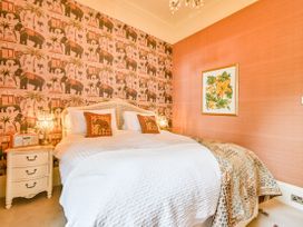 A bedroom with a bed and a nightstand at Muntham Apartment 6 in Torquay
