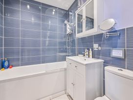 A bathroom with a bathtub and shower at Muntham Apartment 6 in Torquay