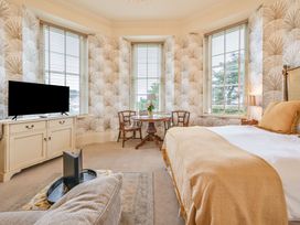 A bedroom with a bed and a table at Muntham - Studio Apartment 7 Torquay