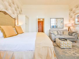 A bedroom with a bed and couch at Muntham - Studio Apartment 7 Torquay