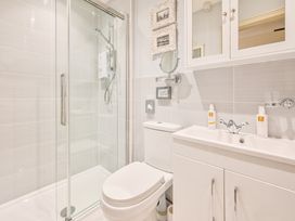 A bathroom with a shower, toilet and sink at Muntham - Studio Apartment 7 in Torquay