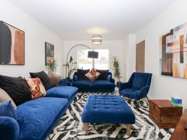 A living room with sofas and artwork at Manor Park View in Norwich