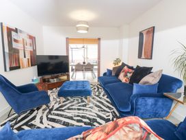A living room with a sofa and an ottoman at Manor Park View in Norwich