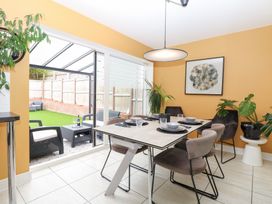 A dining room with a table and chairs at Manor Park View in Norwich