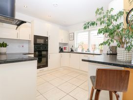A kitchen with cabinets and a countertop at Manor Park View in Norwich